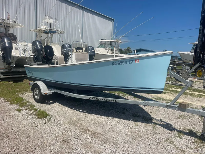 Slide: The Image of 2023 Intruder ISLAND CLASSIC 17 boat on trailer, parked outdoors near other boats. - 4