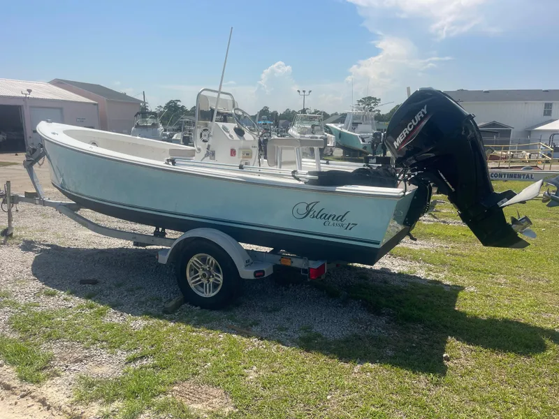 Slide: The Image of 2023 Intruder Island Classic 17 boat on trailer with Mercury outboard motor. - 7