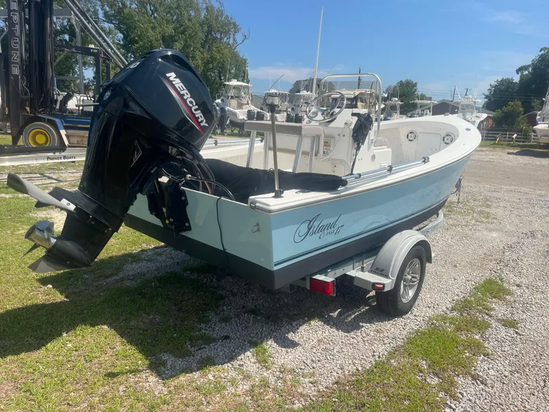 Slide: The Image of 2023 Intruder Island Classic 17 boat with Mercury outboard motor on trailer. - 9