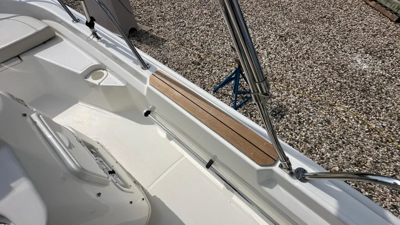 Slide: The Image of 2022 Boston Whaler 150 Montauk interior with stainless steel railings and wood accents. - 14