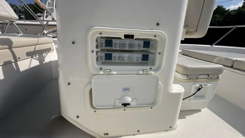 Slide: The Image of 2022 Boston Whaler 150 Montauk boat interior with storage compartments and seating. - 17