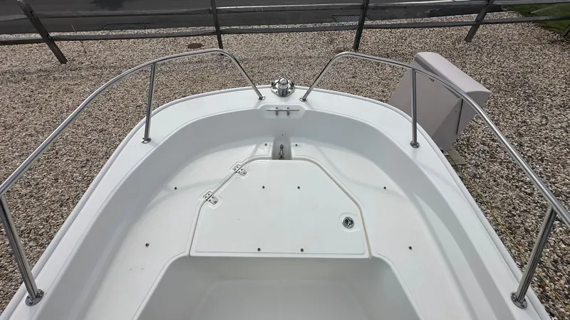 Slide: The Image of 2022 Boston Whaler 150 Montauk boat deck with stainless steel railings. - 21