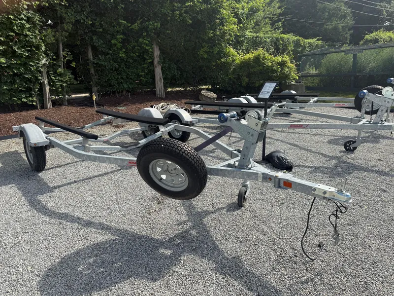 Slide: The Image of Boat trailer for 2022 Boston Whaler 150 Montauk on gravel lot. - 26