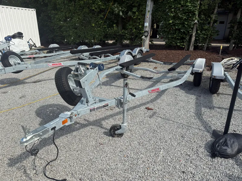 Slide: The Image of Trailer for 2022 Boston Whaler 150 Montauk on gravel lot. - 27