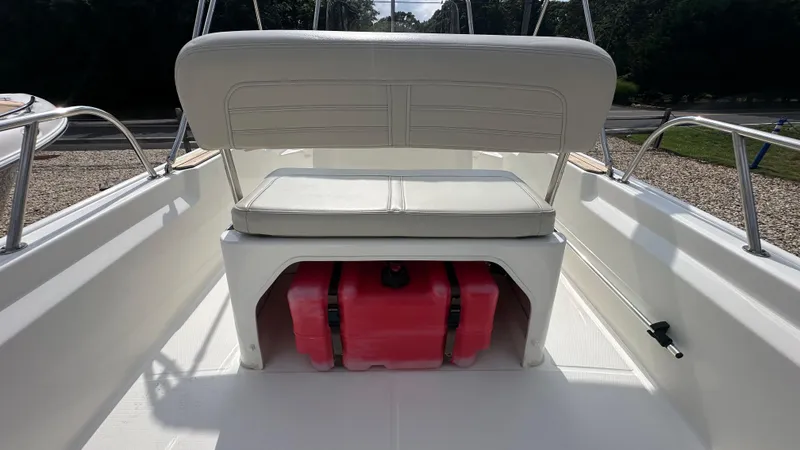 Slide: The Image of 2022 Boston Whaler 150 Montauk interior with seating and storage compartment. - 9