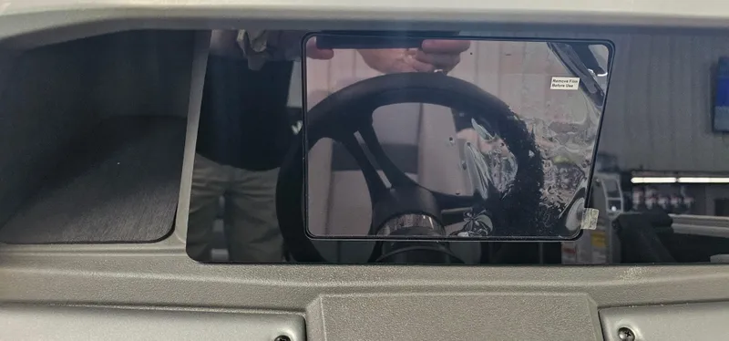 Slide: The Image of 2026 Sun Tracker PB-20 dashboard with steering wheel and protective film. - 11
