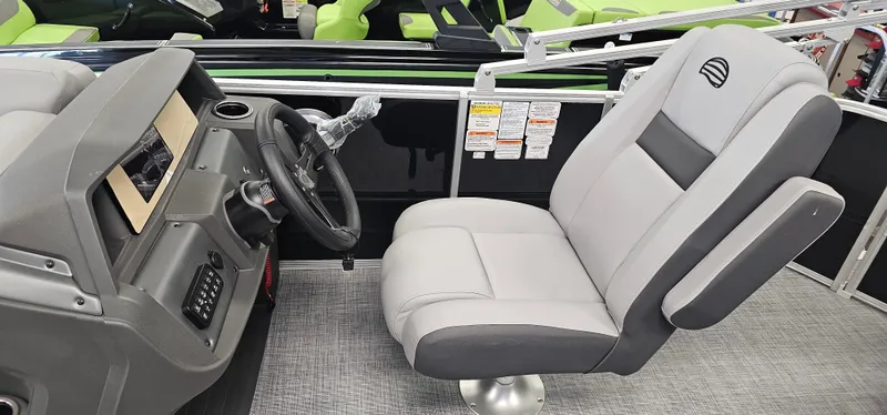 Slide: The Image of 2026 Sun Tracker PB-20 boat interior with gray captain's chair and modern dashboard. - 8