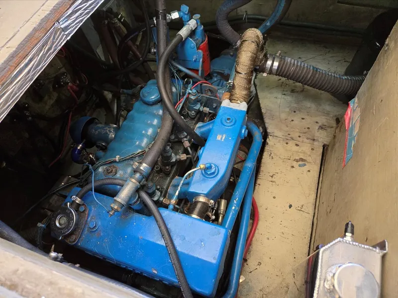 Slide: The Image of 1974 Willard Nomad boat deck with docked vessels and marina reflections. - 15