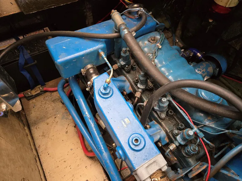 Slide: The Image of 1974 Willard Nomad boat deck with yellow rope, docked at marina. - 16