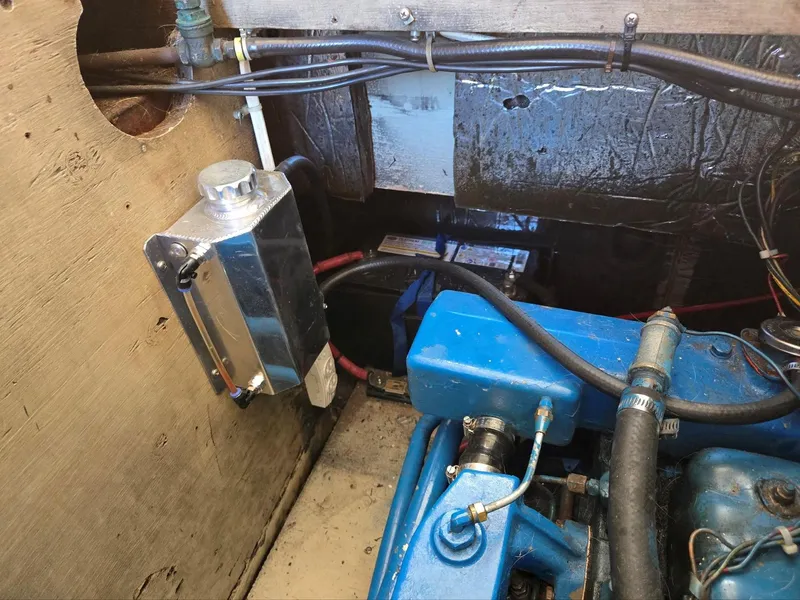 Slide: The Image of 1974 Willard Nomad boat helm with wooden accents and steering wheel. - 17