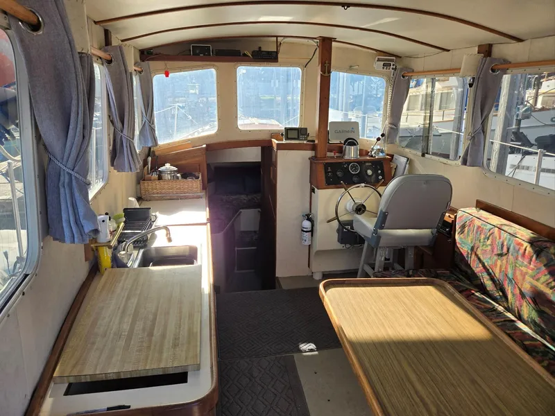 Slide: The Image of 1974 Willard Nomad boat helm with wooden accents, docked in a marina. - 18