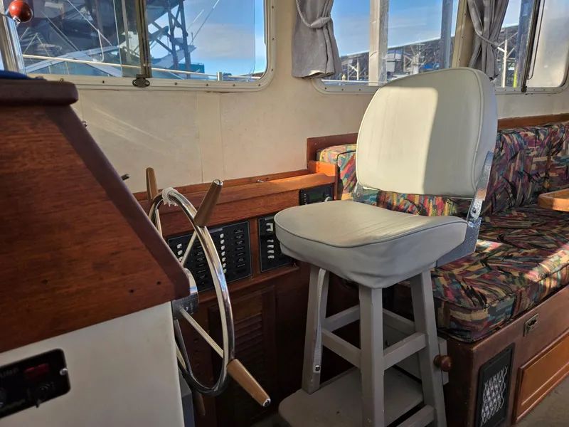 Slide: The Image of 1974 Willard Nomad engine, blue, with hoses and components in a boat compartment. - 19