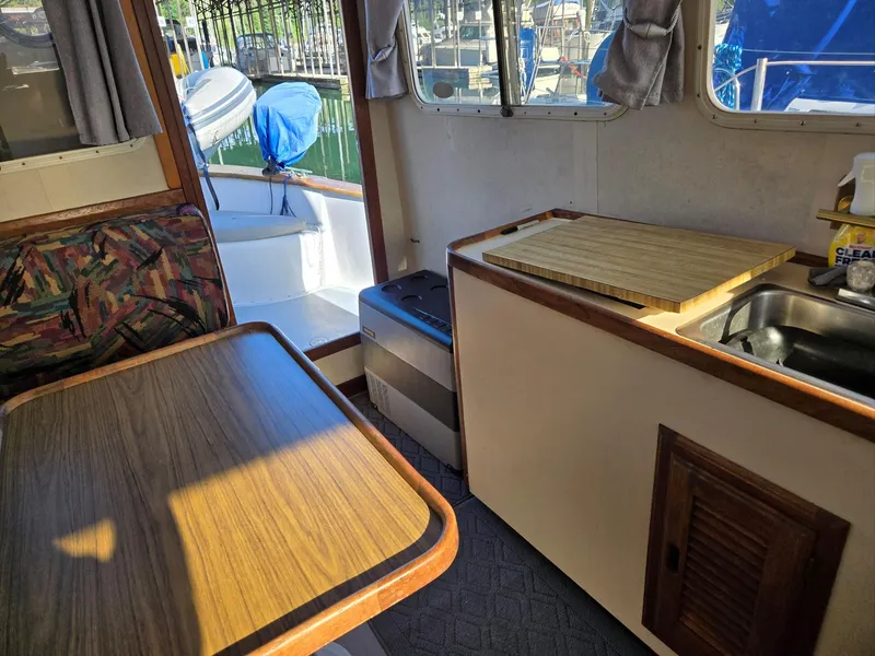 Slide: The Image of 1974 Willard Nomad engine, blue with visible hoses and wiring, in a boat compartment. - 20