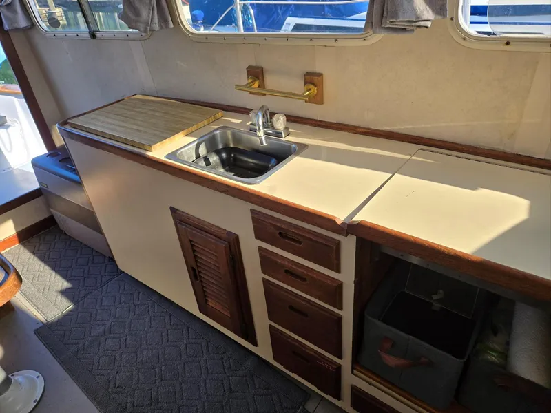 Slide: The Image of 1974 Willard Nomad engine compartment with blue engine and metal components. - 21