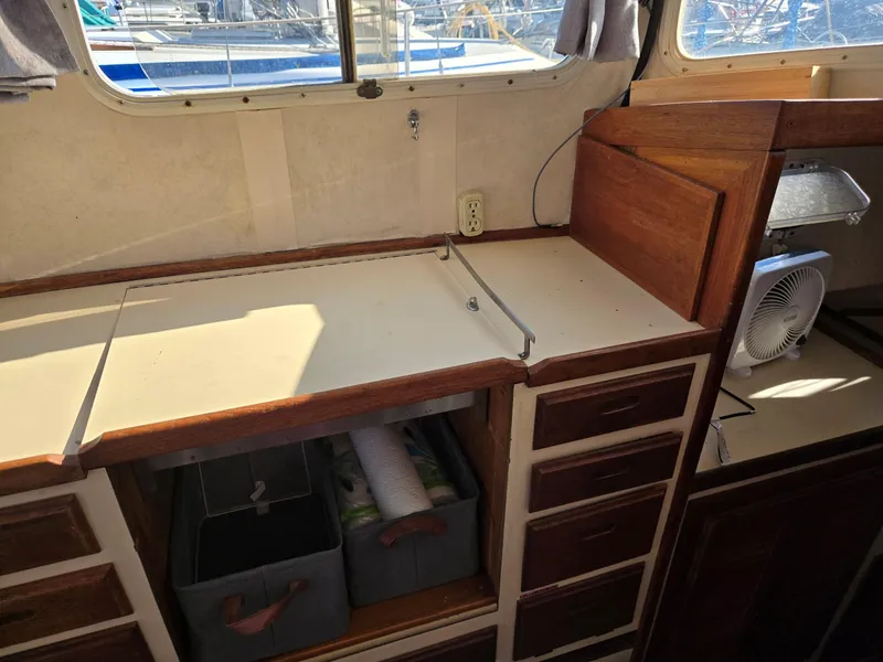 Slide: The Image of Interior of a 1974 Willard Nomad boat with helm, seating, and kitchenette. - 22