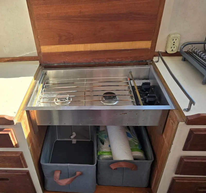 Slide: The Image of Interior of a 1974 Willard Nomad boat with steering wheel and seating area. - 23