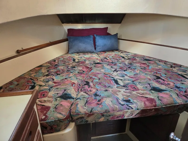 Slide: The Image of 1974 Willard Nomad boat interior with sink, wooden cabinets, and countertop. - 25