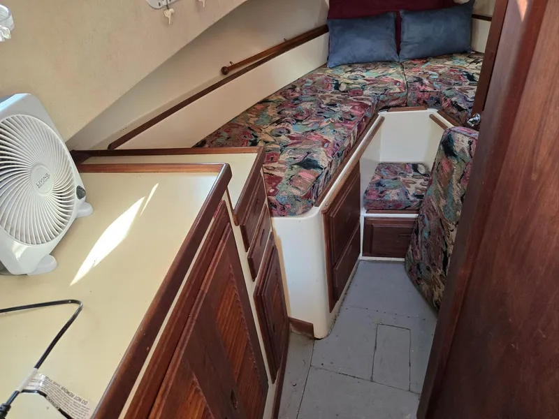 Slide: The Image of 1974 Willard Nomad interior with wooden cabinets, storage bins, and a small fan. - 26