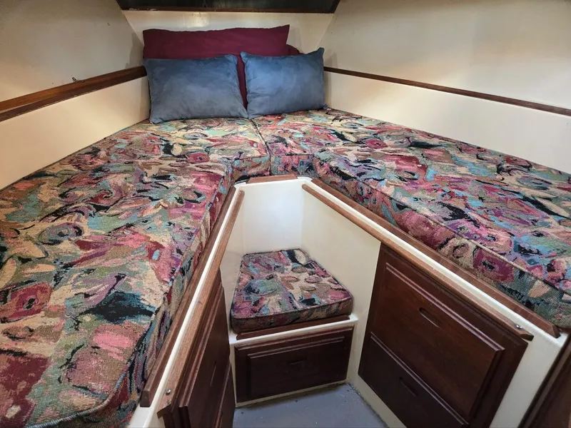 Slide: The Image of 1974 Willard Nomad interior with patterned cushions and wooden storage drawers. - 31