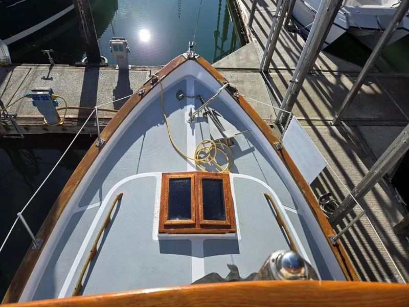 Slide: The Image of 1974 Willard Nomad boat on dry dock with workers, coordinates displayed above. - 5