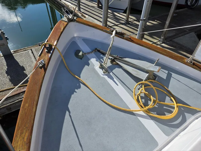 Slide: The Image of 1974 Willard Nomad boat being lifted by crane at a marina. - 6