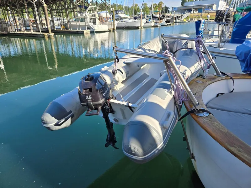 Slide: The Image of 1974 Willard Nomad boat docked, showing deck and marina reflections. - 9