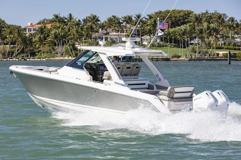 Slide: The Image of 2026 Tiara Yachts 34 LS boat for sale, displayed on stands, blue hull. - 2