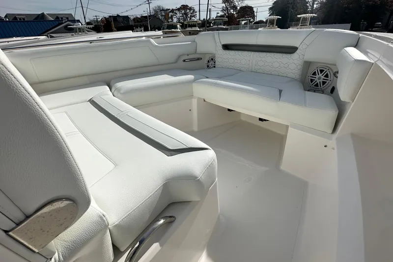 Slide: The Image of Luxurious seating area on 2026 Tiara Yachts 34 LS, featuring white upholstery and modern design. - 21