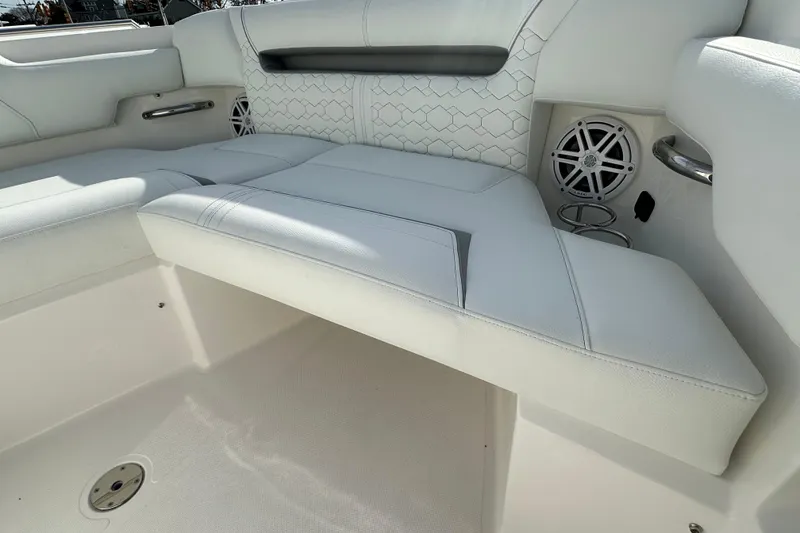 Slide: The Image of 2026 Tiara Yachts 34 LS interior seating with white upholstery and built-in speakers. - 22