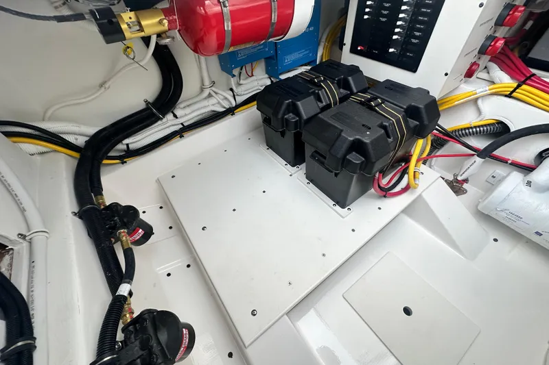 Slide: The Image of Engine compartment of 2026 Tiara Yachts 34 LS, featuring batteries and wiring. - 26