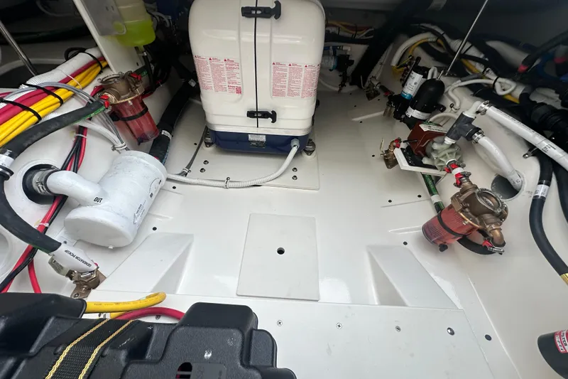 Slide: The Image of Engine compartment of 2026 Tiara Yachts 34 LS, showcasing mechanical components and wiring. - 27