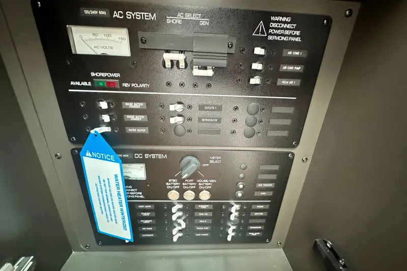 Slide: The Image of Electrical control panel of 2026 Tiara Yachts 34 LS, featuring AC and DC systems. - 29