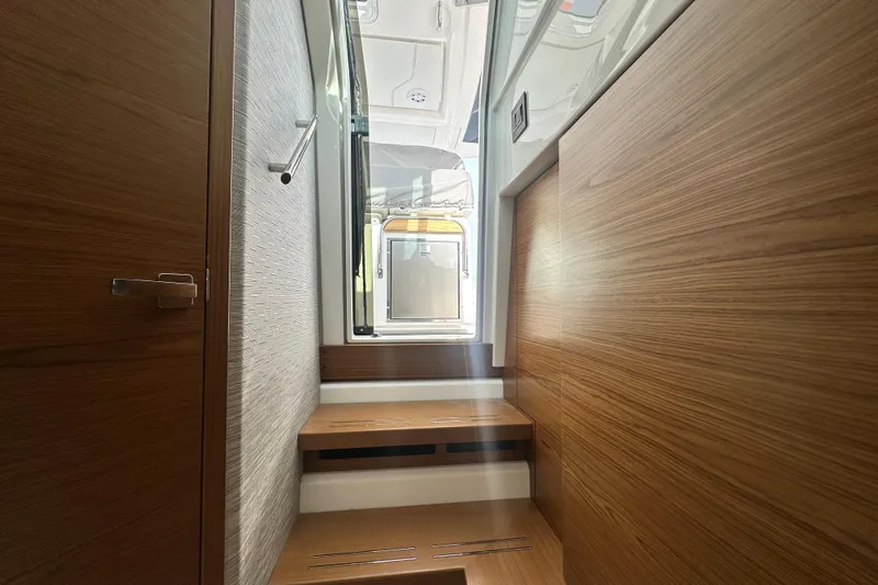 Slide: The Image of Interior of 2026 Tiara Yachts 34 LS, featuring sleek wooden finishes and modern design. - 30