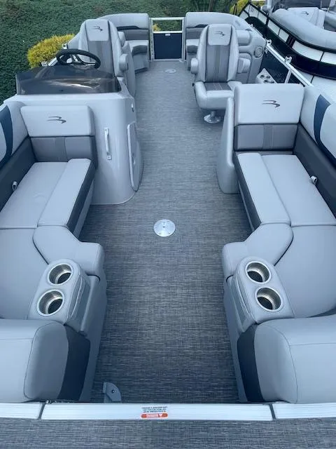 Slide: The Image of 2024 Bennington 22SXSR pontoon boat interior with gray seating and cup holders. - 3