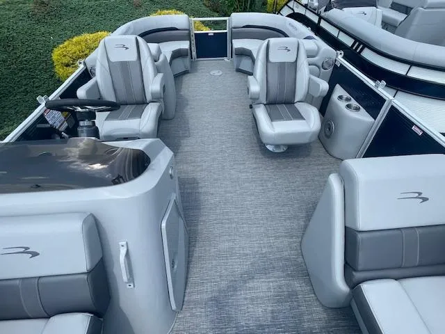 Slide: The Image of 2024 Bennington 22SXSR pontoon boat interior with gray seating and spacious layout. - 4