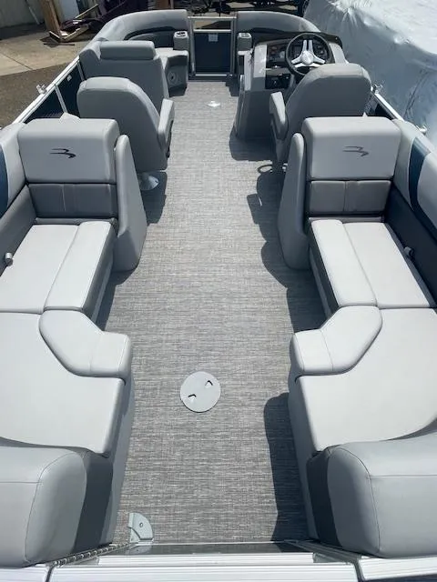 Slide: The Image of 2024 Bennington 22SXSR pontoon boat interior with gray seating and steering console. - 5