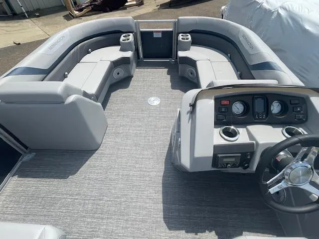 Slide: The Image of 2024 Bennington 22SXSR pontoon boat interior with plush seating and modern dashboard. - 6