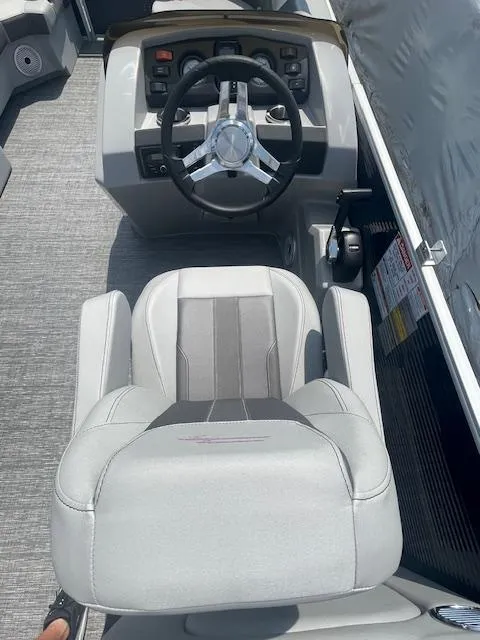 Slide: The Image of 2024 Bennington 22SXSR boat helm with steering wheel and captain's chair. - 7