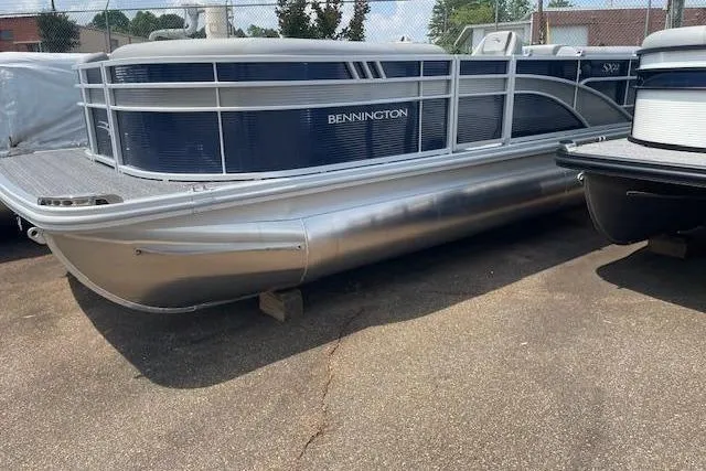 Slide: The Image of 2024 Bennington 22SXSR pontoon boat in a parking lot, side view. - 8