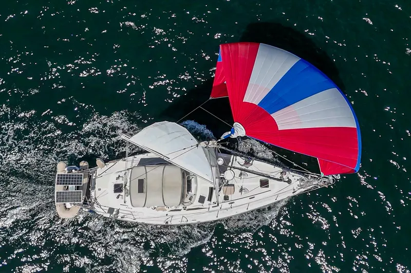The Image of Aerial view of 2001 Hylas 49 sailboat with colorful spinnaker on open water. - 0