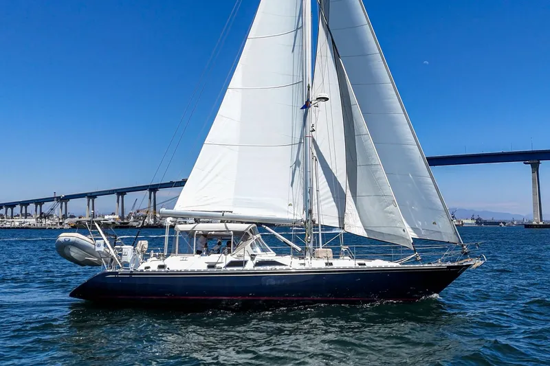 Slide: The Image of Sailing yacht Hylas 49, 2001 model, cruising near a bridge on a sunny day. - 10