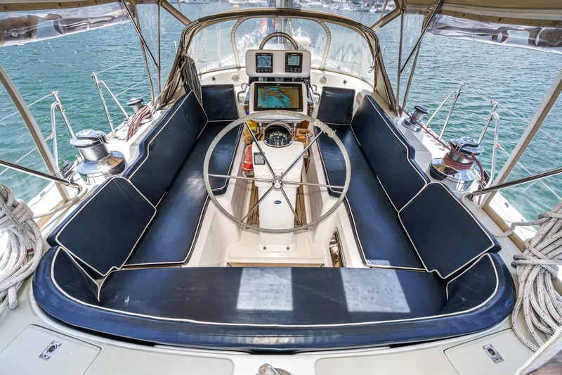 Slide: The Image of Cockpit of 2001 Hylas 49 yacht with navigation equipment and blue seating. - 13