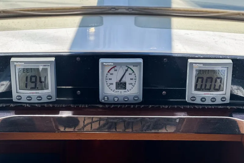 Slide: The Image of Instrument panel on a 2001 Hylas 49 sailboat showing depth, wind, and speed readings. - 22