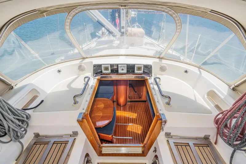 Slide: The Image of Cockpit of 2001 Hylas 49 sailboat with wooden flooring and nautical equipment. - 23