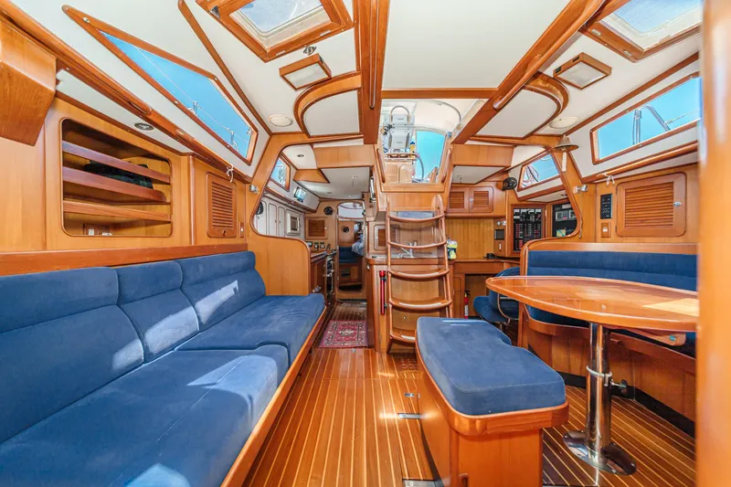 Slide: The Image of Interior of 2001 Hylas 49 yacht with wooden finish and blue seating. - 26