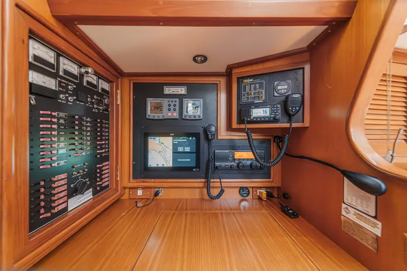 Slide: The Image of Navigation and communication panel inside a 2001 Hylas 49 yacht, featuring GPS and radio equipment. - 27