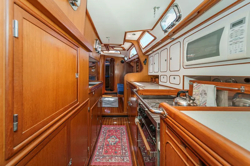 Slide: The Image of Luxurious wooden interior of a 2001 Hylas 49 yacht kitchen with modern amenities. - 32