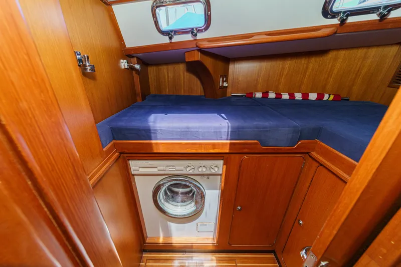 Slide: The Image of Cozy cabin interior of 2001 Hylas 49 yacht with bed and washing machine. - 33