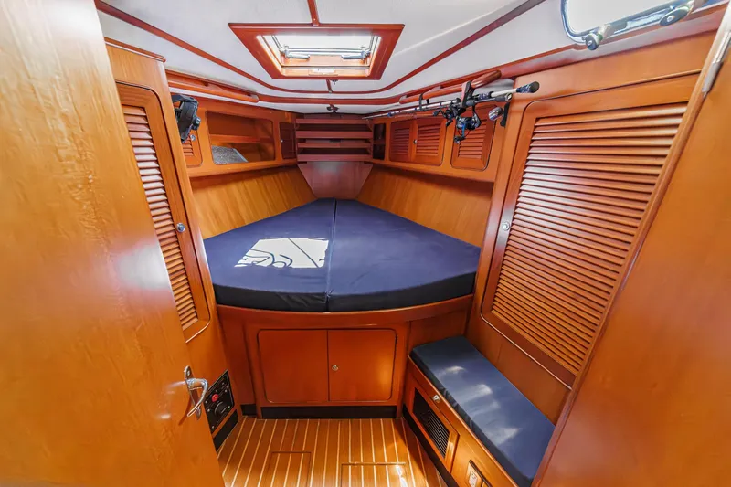 Slide: The Image of Interior of 2001 Hylas 49 yacht cabin with wooden finish and cozy bed. - 34