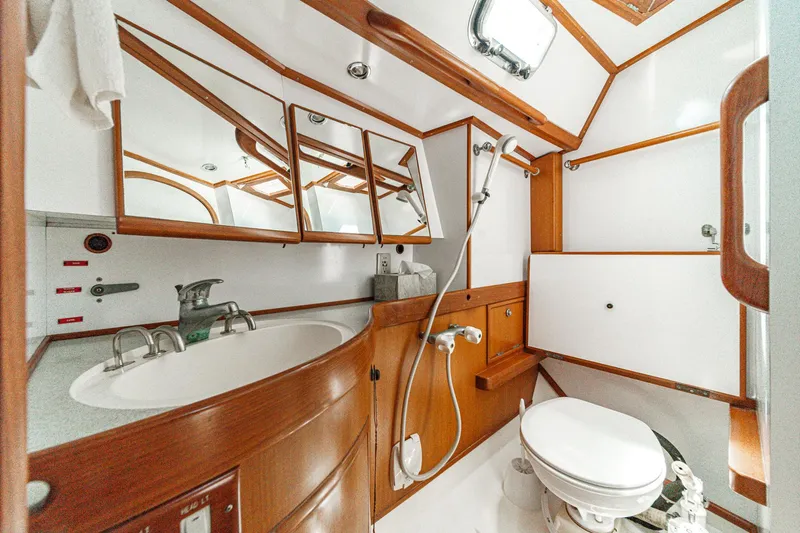 Slide: The Image of Luxurious bathroom in a 2001 Hylas 49 yacht, featuring wood accents and modern fixtures. - 35